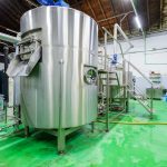 Large fermenting tank inside brewery production premises